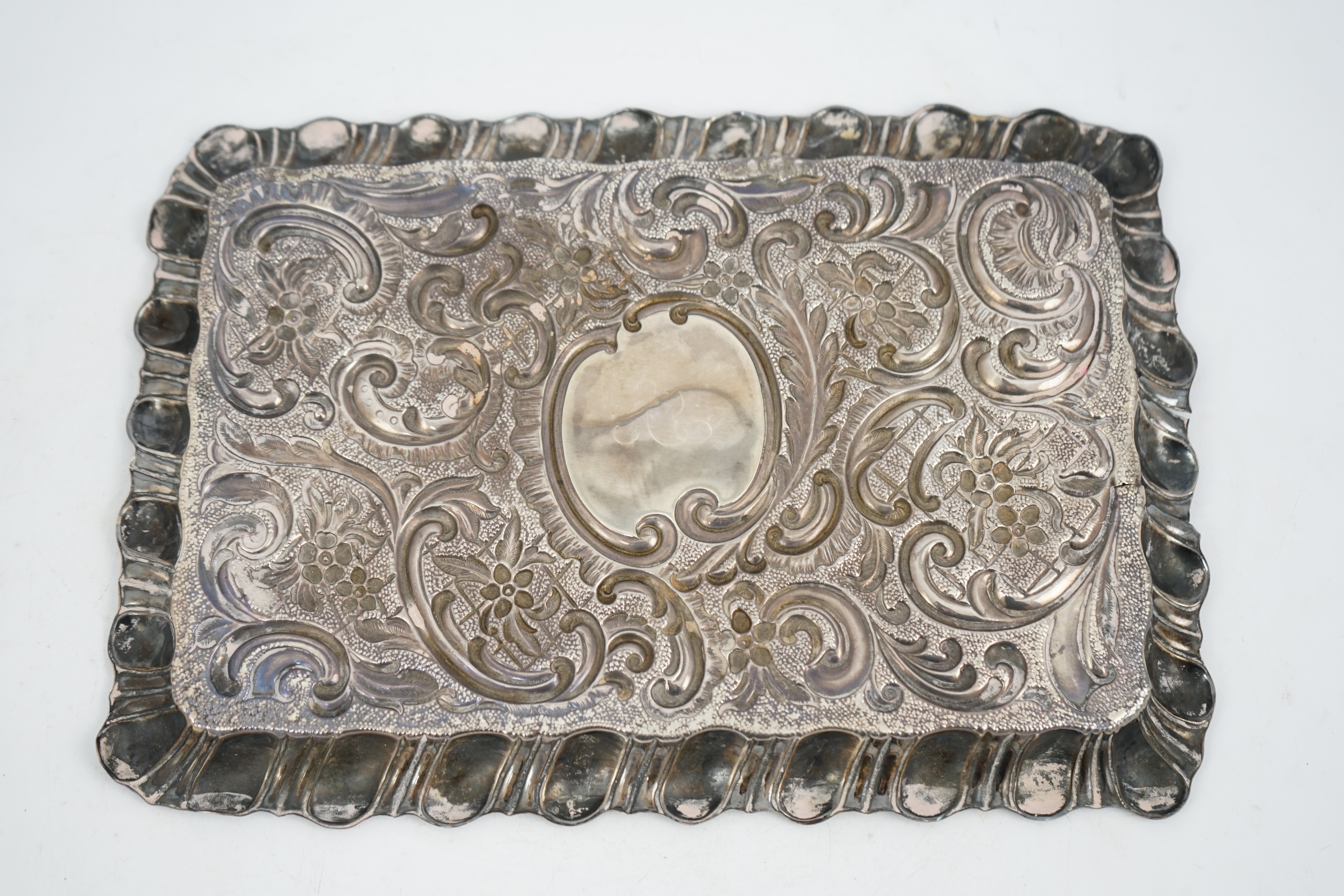 An Edwardian repousse silver dressing table tray, A&J Zimmerman, Birmingham, 1901, 30cm